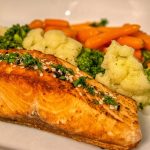 Delicious grilled salmon served with vibrant mixed vegetables, perfect for a healthy meal.